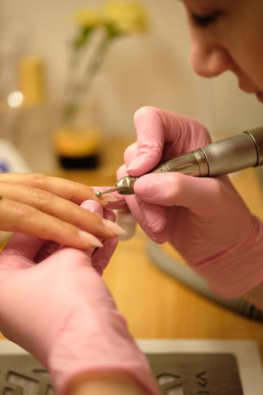 E-file nail drill close-up showing precision cuticle work