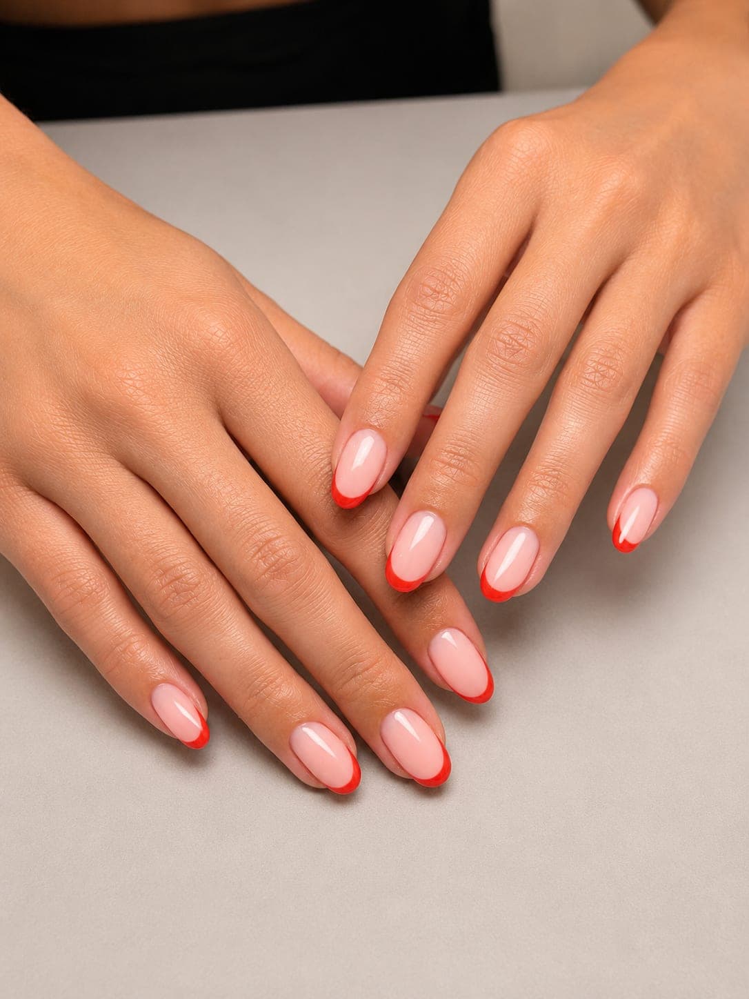 Thin red French tips on oval nails