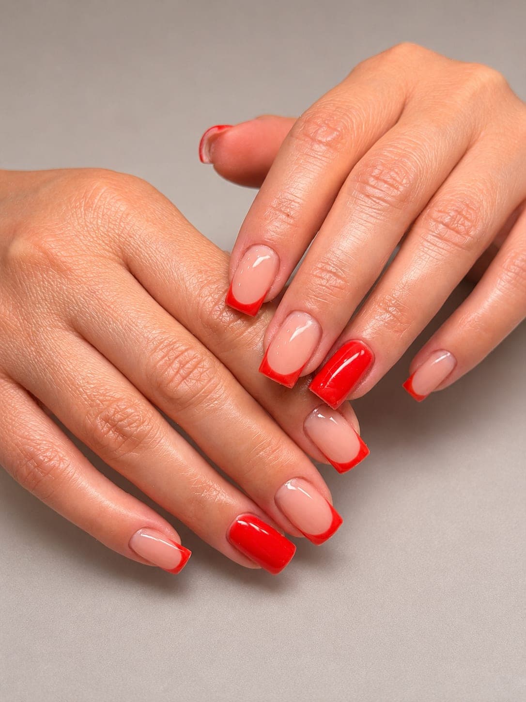 Red square nails with a single red accent design